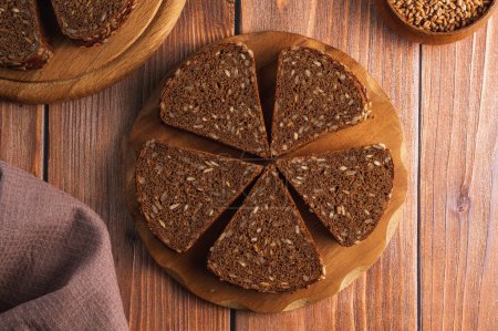 Photo for Homemade rye bread with seeds on a wooden board - Royalty Free Image
