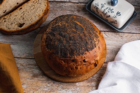 Photo for Homemade bread in the form of a circle sprinkled with poppy seed - Royalty Free Image