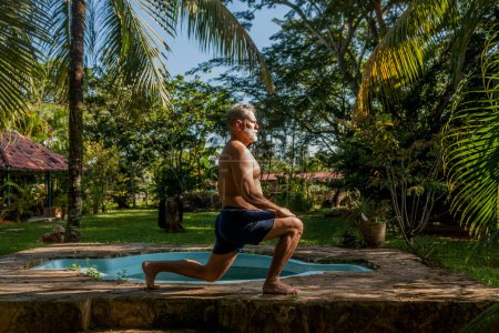 Photo for Attractive mature caucasian man performs isometric exercises - Royalty Free Image