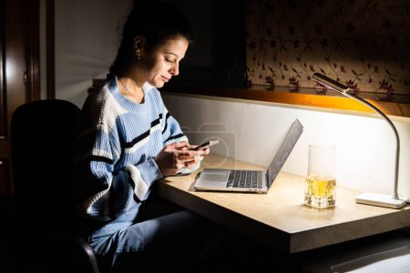 Photo for Girl working on computer at home at night - Royalty Free Image