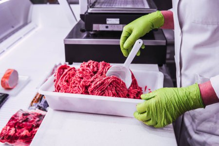 Téléchargez les photos : Butcher selling red meat minced meat - en image libre de droit