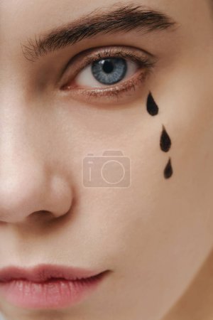 Photo for Close-up portriat of a crying woman with flowing make-up - Royalty Free Image