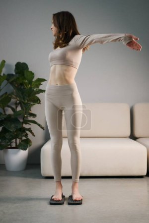 Foto de Woman on wooden board with sharp metal nails sadhu yoga board - Imagen libre de derechos