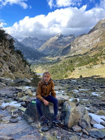 Photo for The boy is hiking in the Benasque valley, Pyrenees. - Royalty Free Image