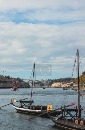 Photo for Two small boats with barrels in the port - Royalty Free Image