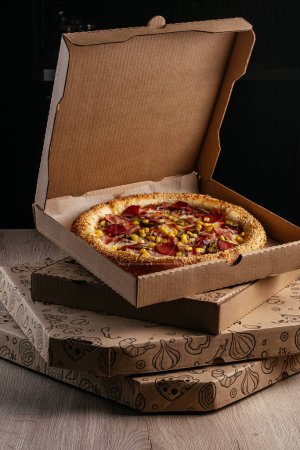 Photo for Pizza from a cardboard box for delivery - Royalty Free Image