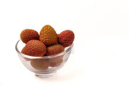 Photo for Fresh lychees in a clear glass bowl isolated on a white background - Royalty Free Image