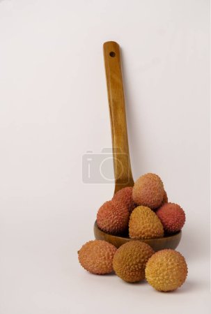 Photo for Fresh lychees in a wooden spoon isolated on a white background - Royalty Free Image
