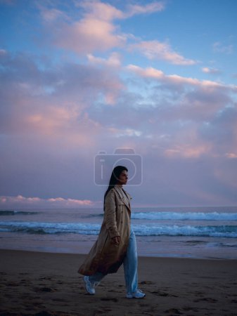 Photo for Young free Woman walking on the Atlantic Ocean - Royalty Free Image