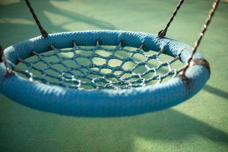 Foto de Round swing for children. Swing on ropes. Details of playground. - Imagen libre de derechos
