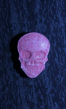 Photo for Pink skull ecstasy pill close up background high quality prints purple army dope narcotics substance high dose psychedelic way of life - Royalty Free Image