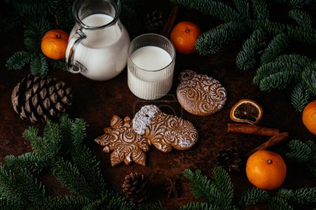 Foto de Christmas table with gingerbread , tangerines and  milk - Imagen libre de derechos