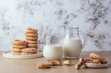 Photo for Milk in a glass and bagels on a light background - Royalty Free Image