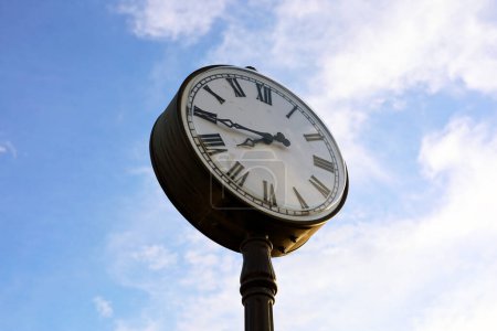 Photo for The clock face on the background of the blue sky at sunset - Royalty Free Image