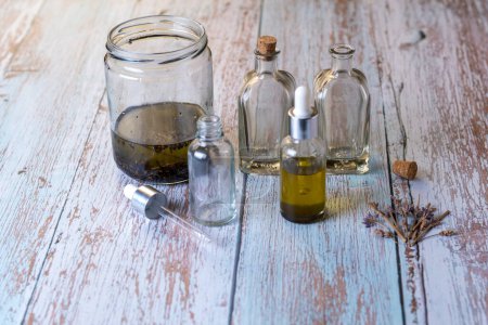 Téléchargez les photos : Home made Lavender Essential oil bottles on wood table - en image libre de droit