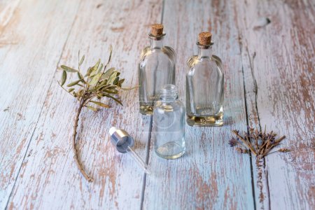 Téléchargez les photos : Home made Lavender Essential oil empty bottles on wood table - en image libre de droit