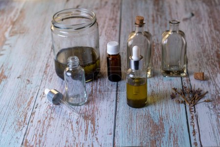 Foto de Home made Lavender Essential oil bottles on wood table - Imagen libre de derechos
