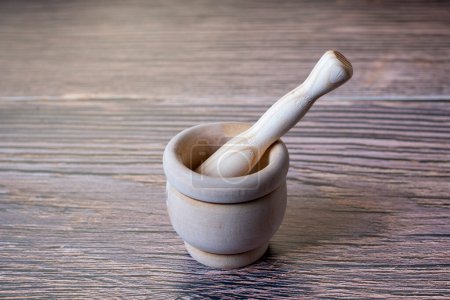 Photo for Wooden mortar and pestle isolated on wooden - Royalty Free Image