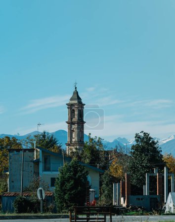 Téléchargez les photos : Exterior of small old church with tower under blue sky on sunny day against mountains - en image libre de droit