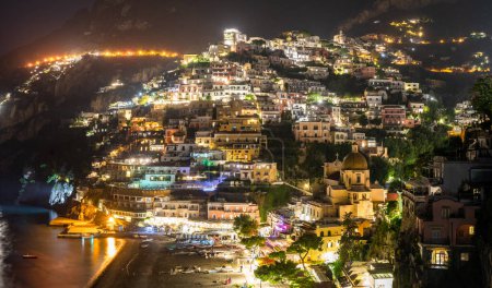 Téléchargez les photos : Lit up Positano at night - en image libre de droit