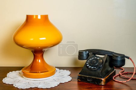 Photo for Interior. VVntage phone and lamp on wooden table. - Royalty Free Image