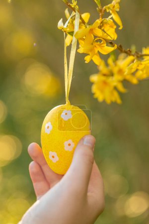 Photo for Yellow egg on blooming yellow branches. Spring religious holiday. - Royalty Free Image