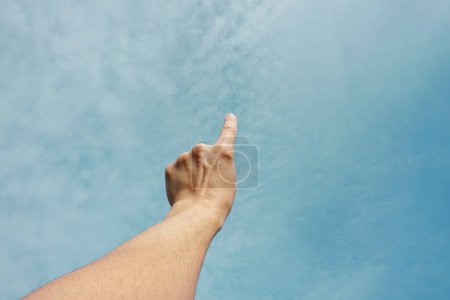 Photo for Man hand up in the air pointing at the sky - Royalty Free Image