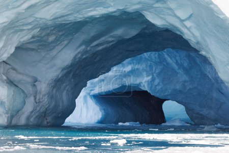 Photo for Double cave in big iceberg floating over sea - Royalty Free Image