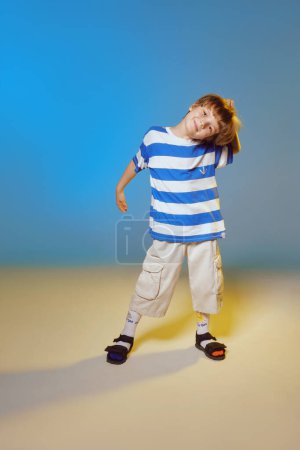 Foto de Joyful kid as sailor. Studio shot on a blue and yellow background. - Imagen libre de derechos
