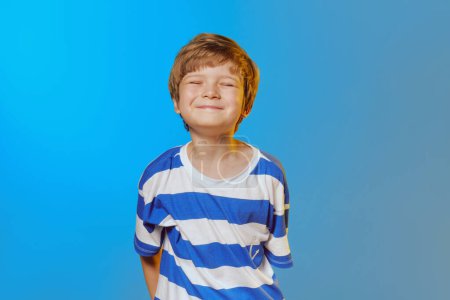 Photo for Joyful kid smiling. Studio shot on a blue and yellow background. - Royalty Free Image