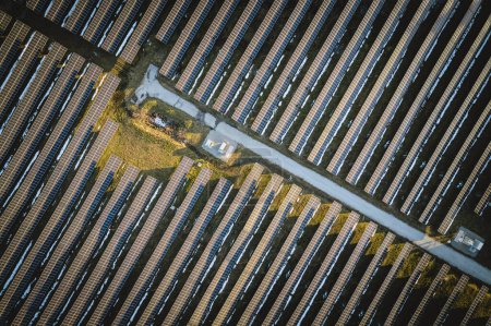 Photo for Aerial view of road through solar panel farm for renewable energy - Royalty Free Image