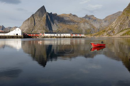 Téléchargez les photos : Red boat in traditional village with mountains for background in - en image libre de droit