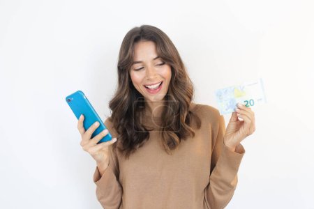 Photo for Earn Money Online Happy Person Holding Smartphone and Cash - Royalty Free Image