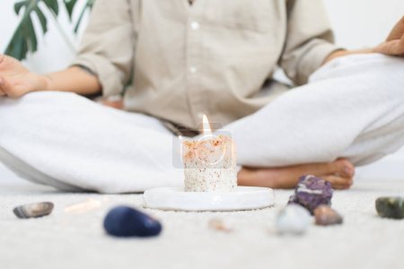 Photo for Person Meditating with Candle and Crystals - Royalty Free Image
