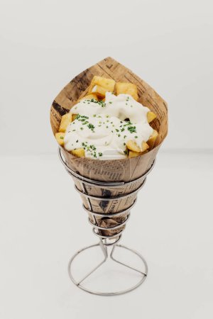 Photo for Spanish fries cone with hot sauce, to take away. - Royalty Free Image