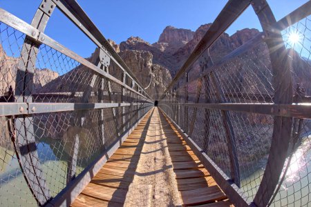 Photo for The Black Bridge that spans the Colorado River at Grand Canyon Arizona along the South Kaibab Trail. This view is looking toward the south rim of the canyon. - Royalty Free Image
