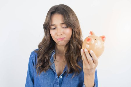 Photo for Worried Person Holding a Piggy Bank Savings - Royalty Free Image