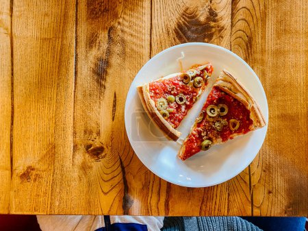 Foto de Deep Dish Pizza with Green Olives on Wood Table - Imagen libre de derechos