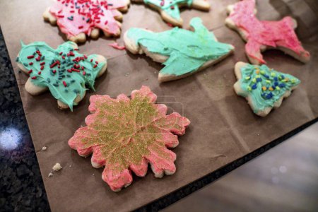 Photo for Colorful Frosted Holiday Sugar Cookies Decorated on Brown Bag - Royalty Free Image