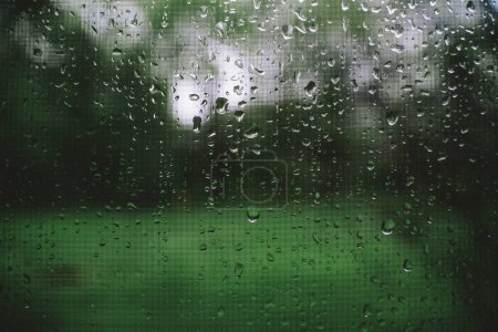 Photo for Raindrops on Window During Storm in Spring - Royalty Free Image