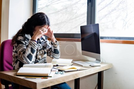 Photo for Woman studying at home desk - Royalty Free Image