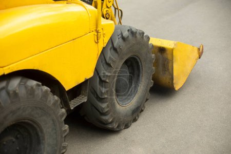 Photo for Yellow mini bulldozer. Small construction equipment. Diesel transport. Yellow conveyor. - Royalty Free Image
