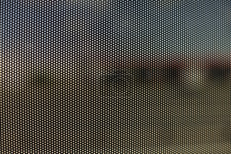 Foto de Mesh texture on glass. Shooting window. Small cage. Textured surface. - Imagen libre de derechos