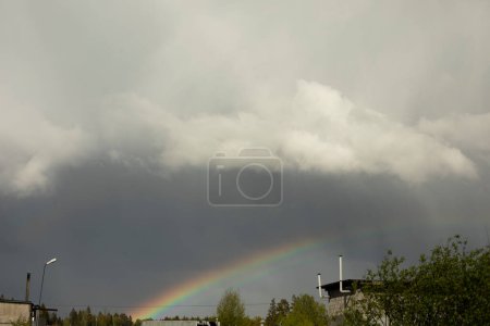 Foto de Rainbow in sky. Rainbow over industrial area. Rainy weather. - Imagen libre de derechos