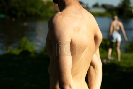 Photo for Guy's back in summer. Man's bare back on hot day. - Royalty Free Image