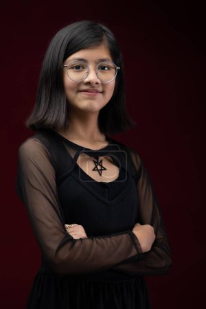 Photo for 12 year old girl portrait isolated on red background wearing glasses - Royalty Free Image