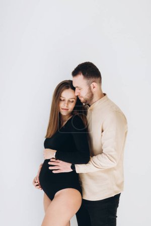 Photo for Man and a pregnant woman waiting for a child hug at home - Royalty Free Image