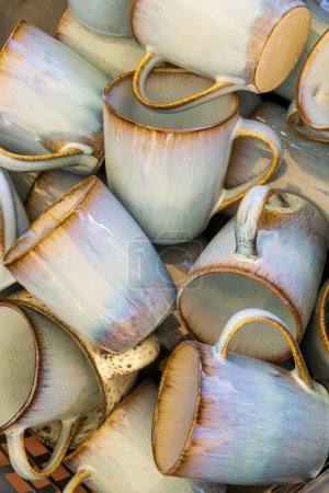 Foto de Handmade ceramic mugs stacks background - Imagen libre de derechos