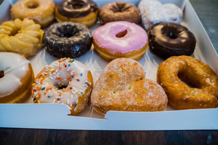 Photo for Close Up of Variety of Donuts in White Box on Table - Royalty Free Image