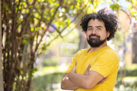 Photo for Portrait of a Mexican man smiling with afro arms crossed copy space - Royalty Free Image